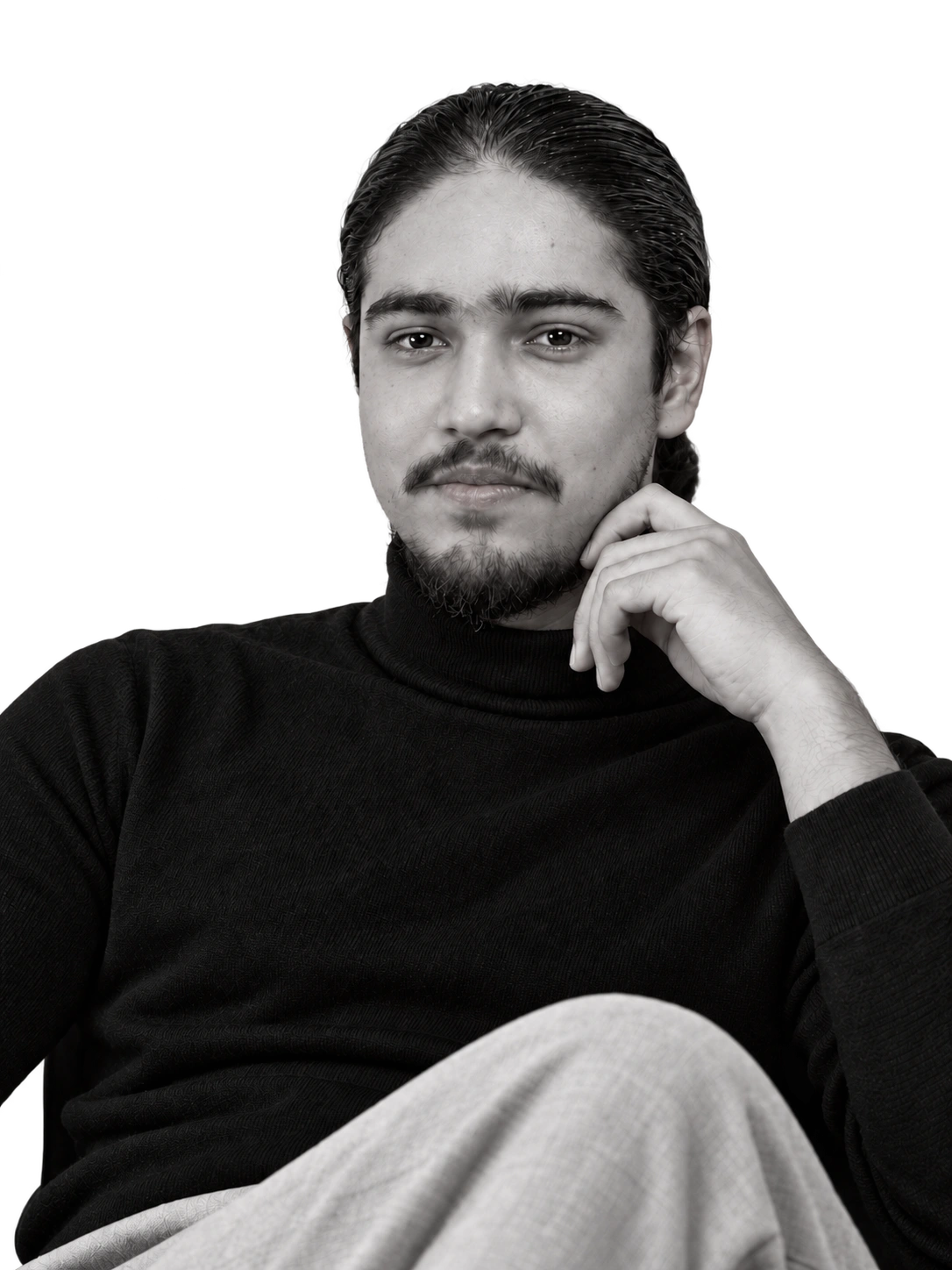 Ahmed Abdullah seated in a black turtleneck.